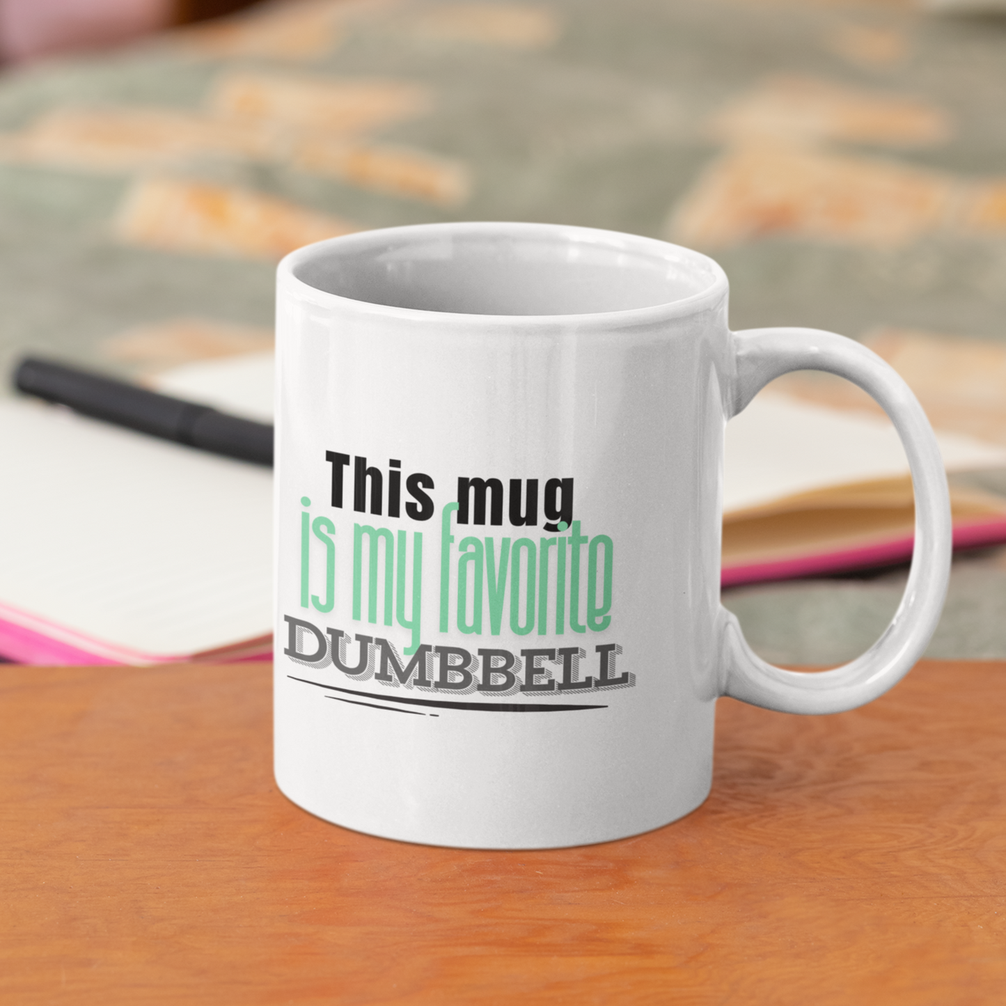 Funny fitness coffee mug on a table with books – 11oz ceramic cup with dumbbell text for gym lovers