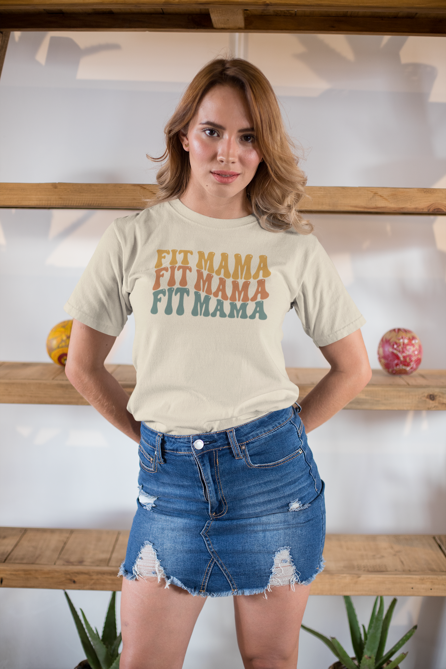 Woman in white Fit Mama shirt with shorts – casual motivational mom t-shirt.