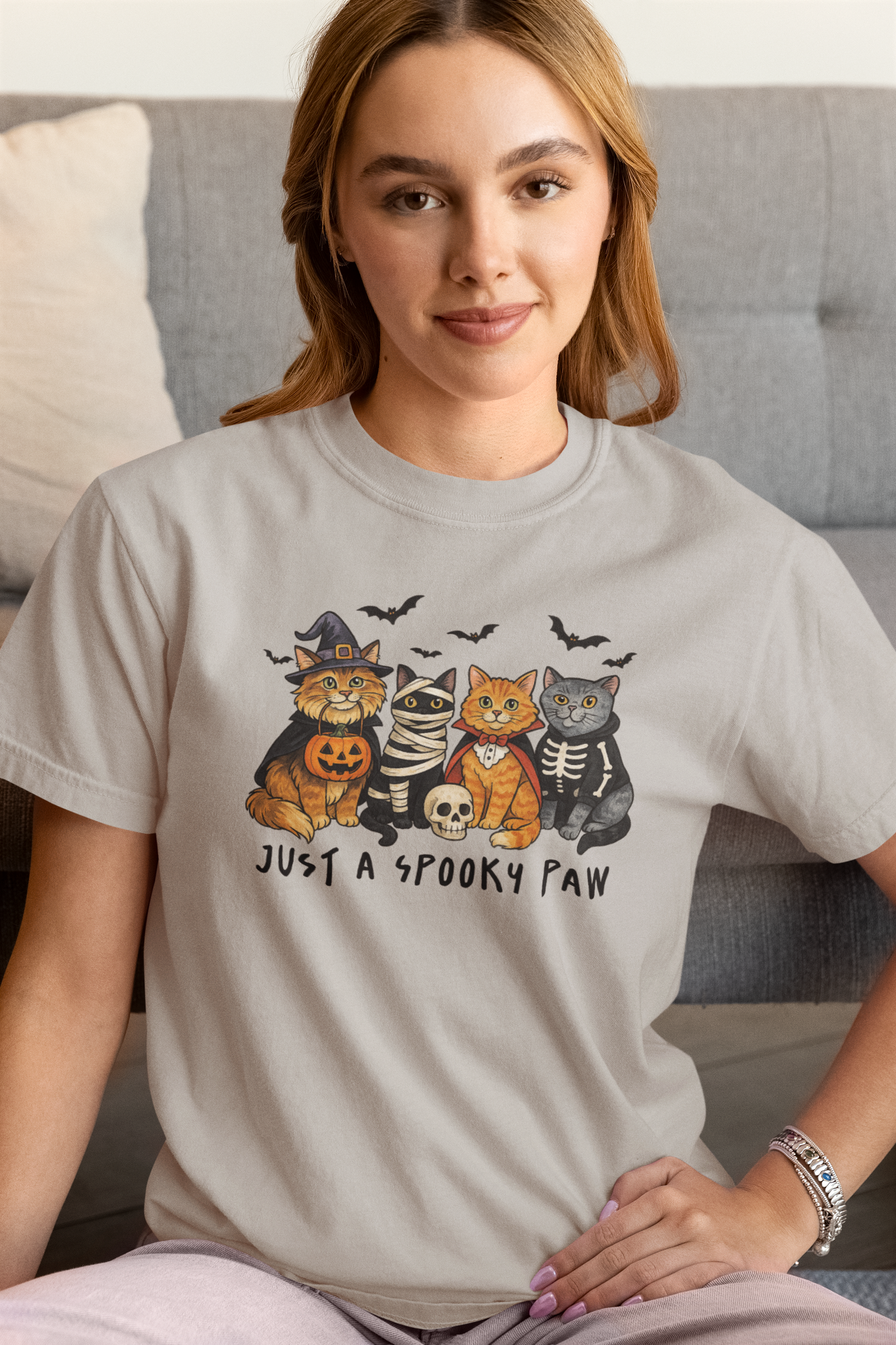 Model wearing Just a Spooky Paw Halloween Cat T-Shirt in grey color