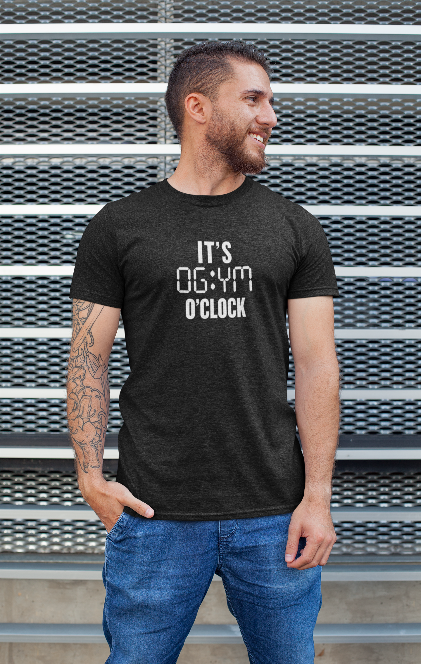 Man wearing black FitBOUND T-shirt with the phrase “It’s Gym O’Clock” standing outdoors – motivational apparel for gym, CrossFit, and running