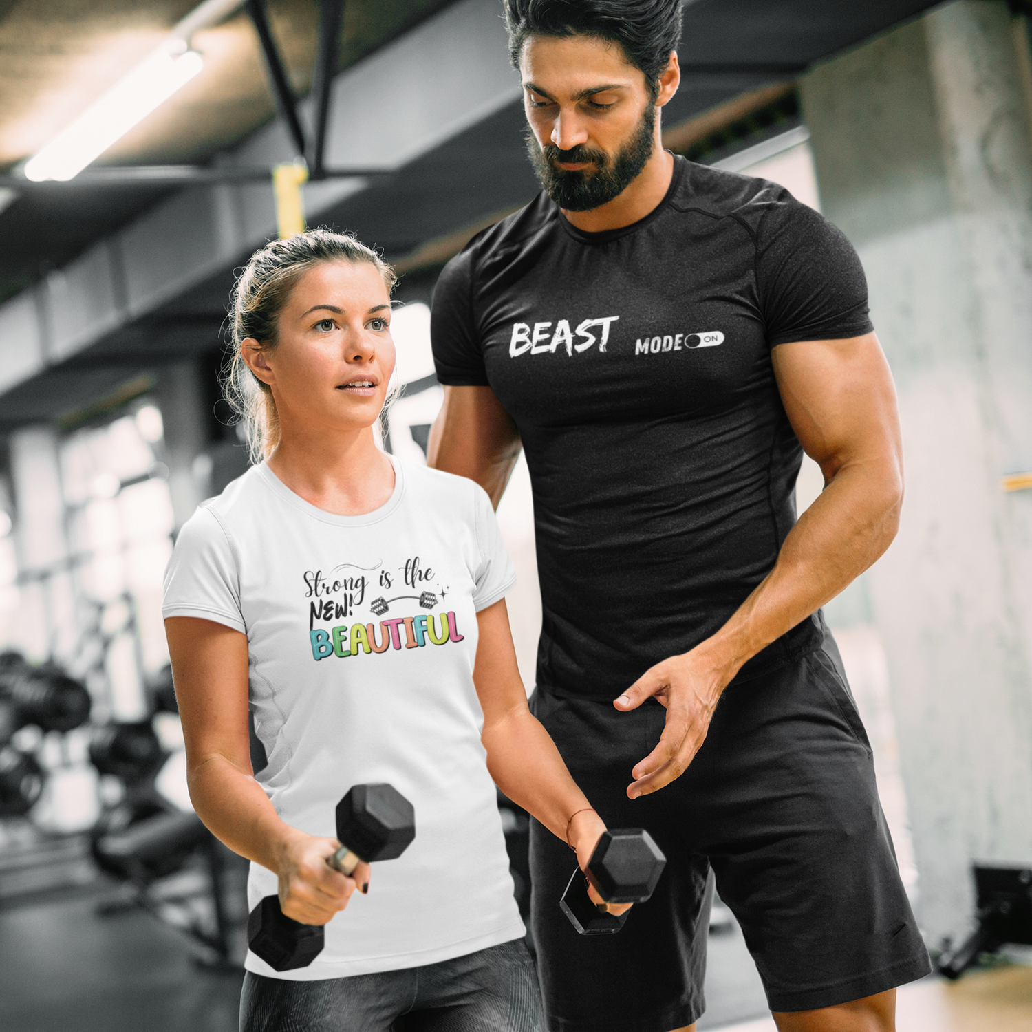 Man and woman wearing FitBOUND motivational gym T-shirts while lifting weights – fitness apparel for active lifestyles
