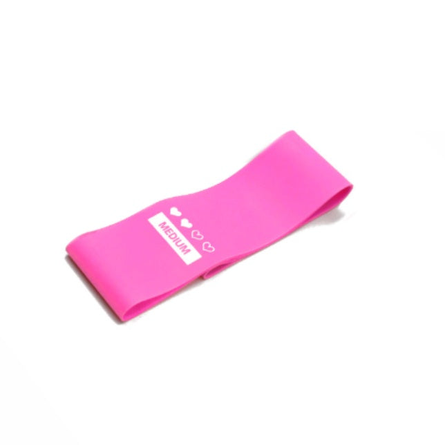 Light pink booty resistance band – compact and stretchable for fitness and home training