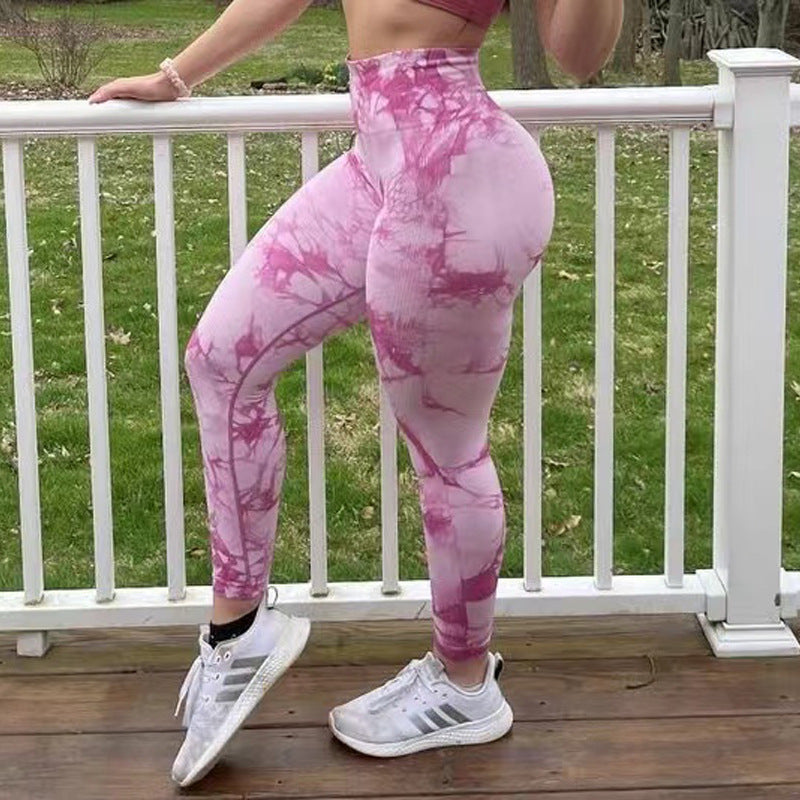 Woman wearing pink tie-dye seamless leggings – high waist and tummy control activewear for fitness and style