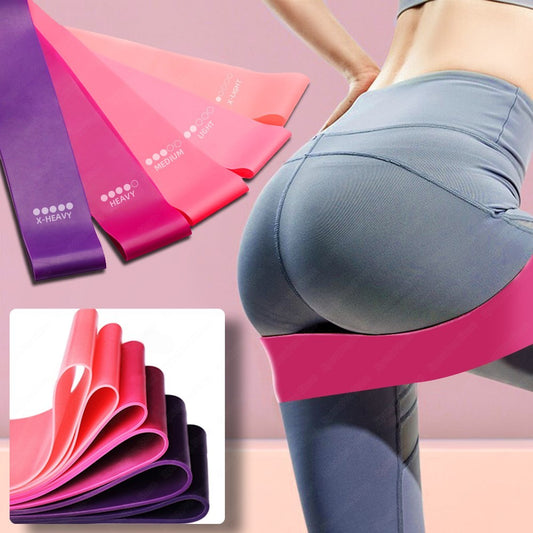 Woman using pink resistance band during glute workout – non-slip fabric band for squats and lower body training