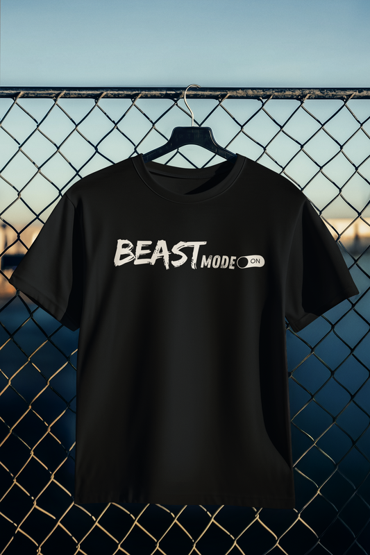 Black "Beast Mode" gym t-shirt hanging on fence – motivational fitness shirt with bold white text