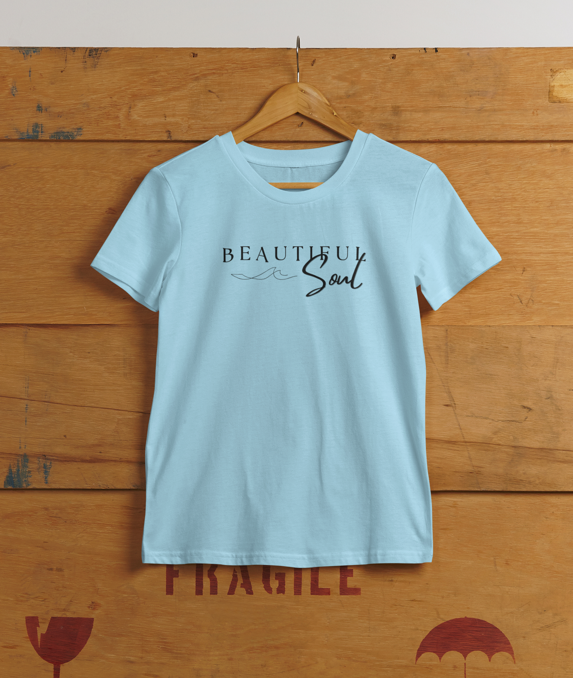 Beautiful Soul T-Shirt hanging on wooden wall – light blue color