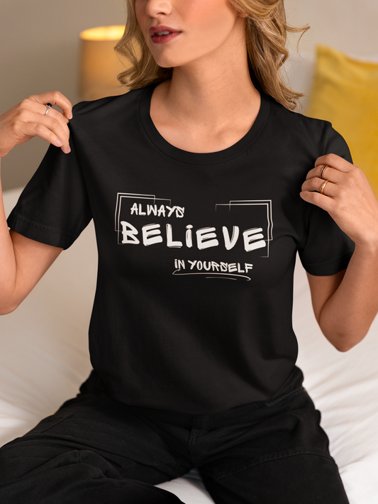 Woman wearing black “Always Believe In Yourself” T-shirt – seated, casual pose.