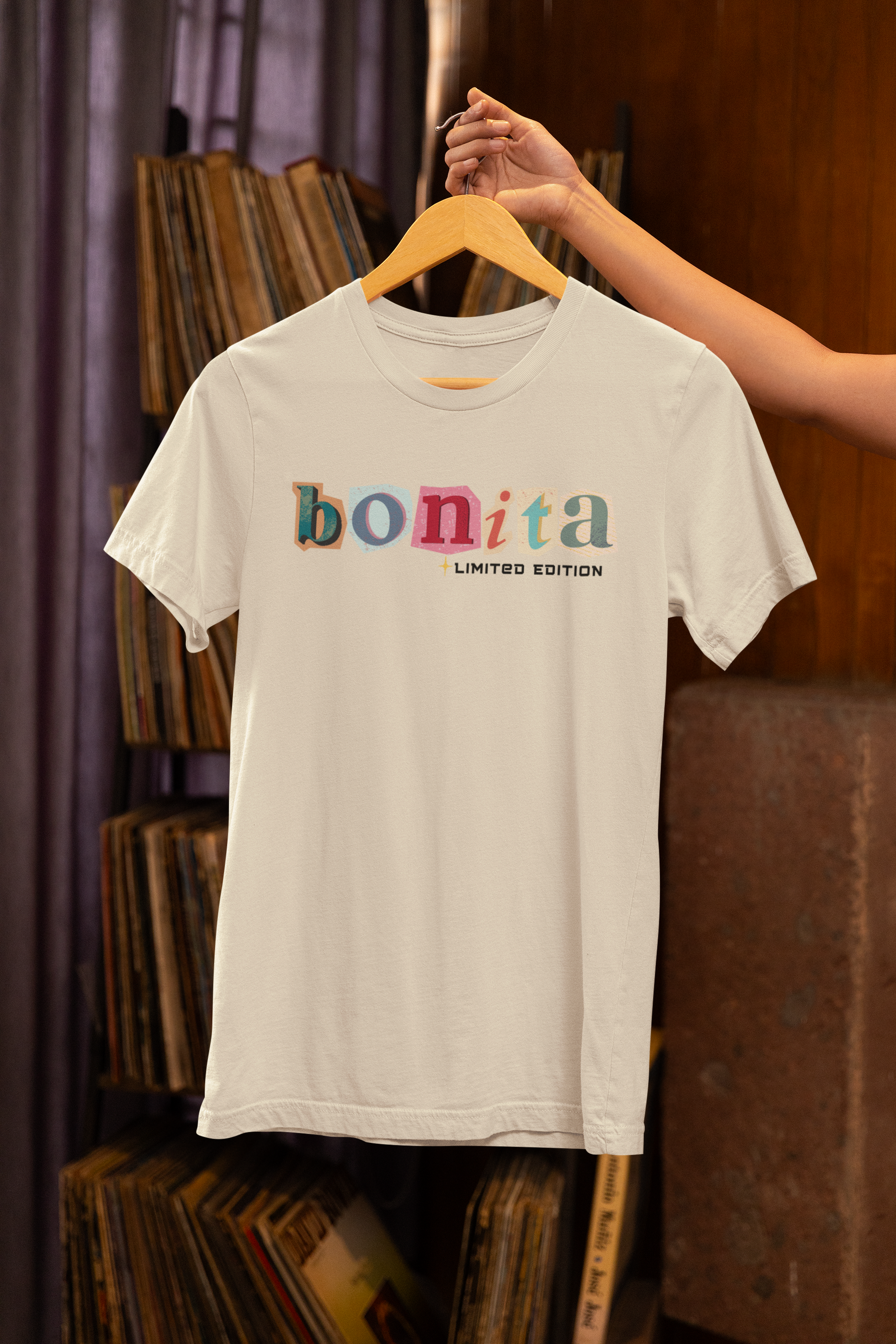 Bonita Limited Edition T-Shirt hanging on wooden hanger – cream color