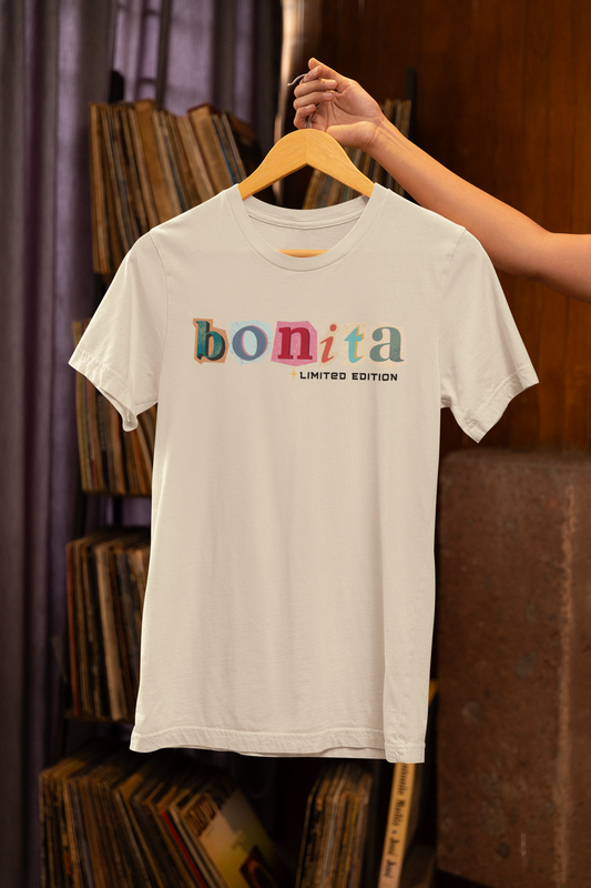 Bonita Limited Edition T-Shirt hanging on wooden hanger – cream color