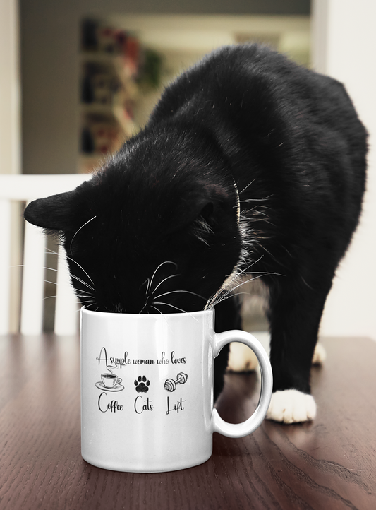 Black cat sniffing a white ceramic mug with the quote “A simple woman who loves coffee, cats, lift” – funny gift for cat moms and fitness lovers