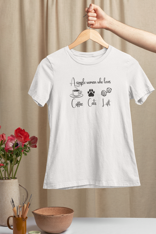 White FitBOUND T-shirt hanging on wooden hanger with the phrase “A simple woman who loves coffee, cats, lift” – cozy fitness shirt for cat moms
