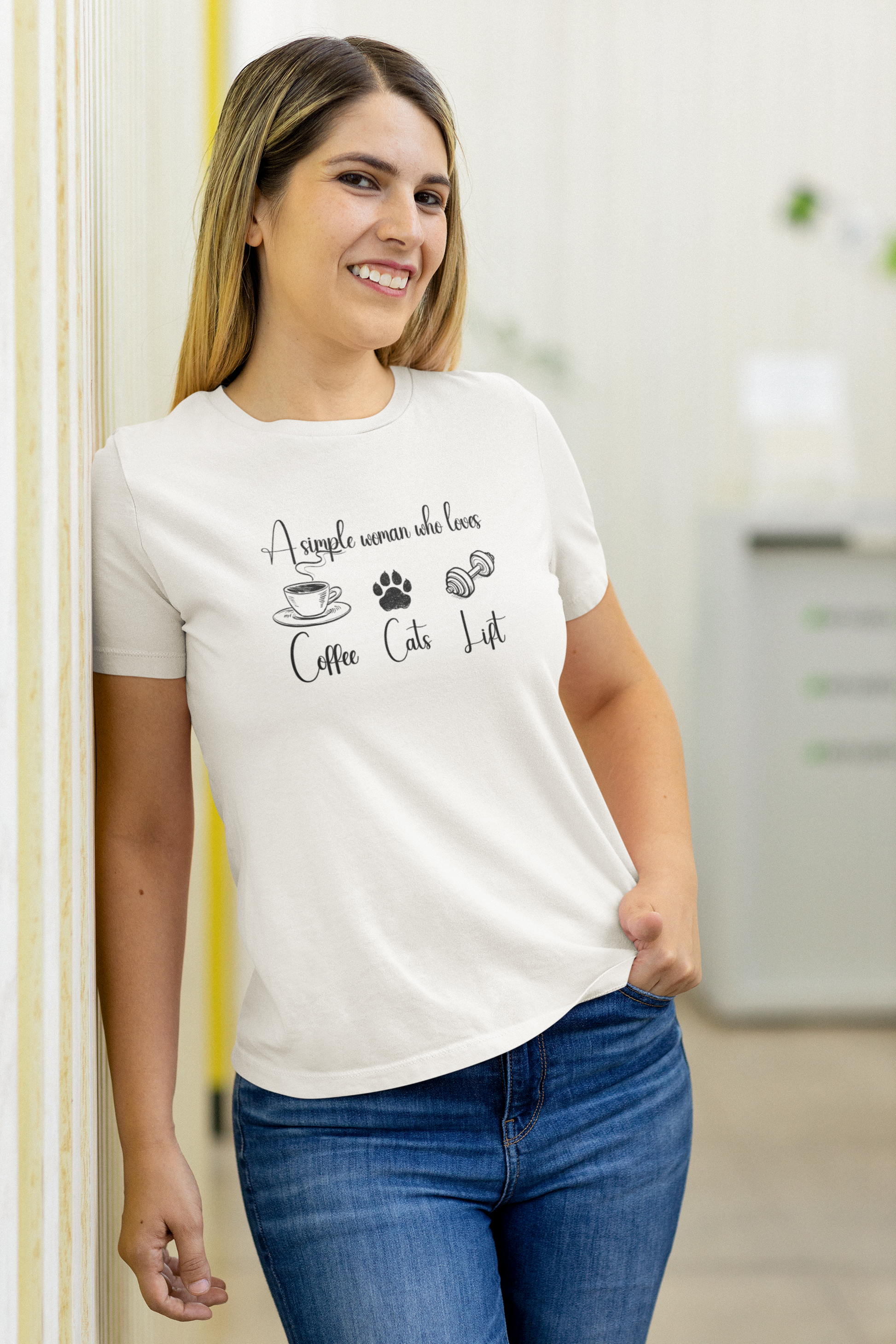 Woman wearing white FitBOUND T-shirt with the phrase “A simple woman who loves coffee, cats, lift” – casual gym and pet lover outfit