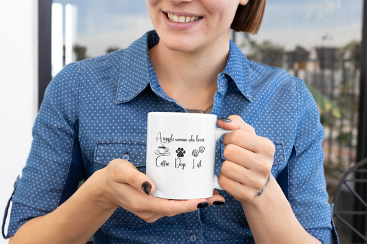 Woman holding white ceramic mug with the quote “A simple woman who loves coffee, dogs, lift” – gift for fitness and dog lovers