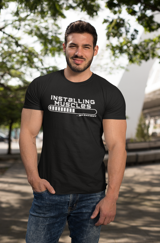 Man wearing funny workout t-shirt with tech-style muscle loading design – fitness tee for gym fans