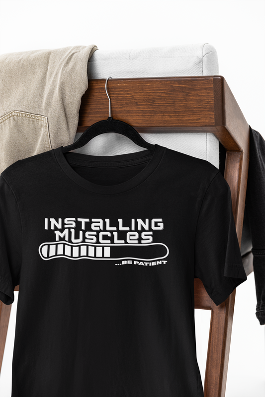 Black t-shirt with “Installing Muscles… Be Patient” loading bar design – funny gym shirt for fitness lovers