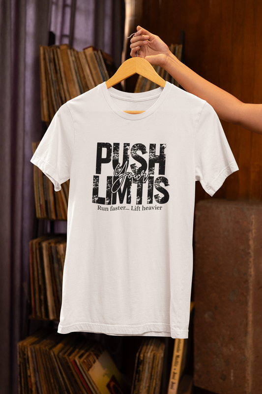 White T-shirt with the phrase “Push Your Limits” hanging on wooden hanger – FitBOUND motivational gym shirt