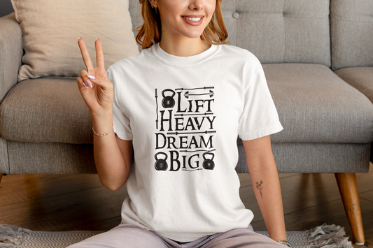 Woman in white Lift Heavy Dream Big gym shirt – casual fitness style.