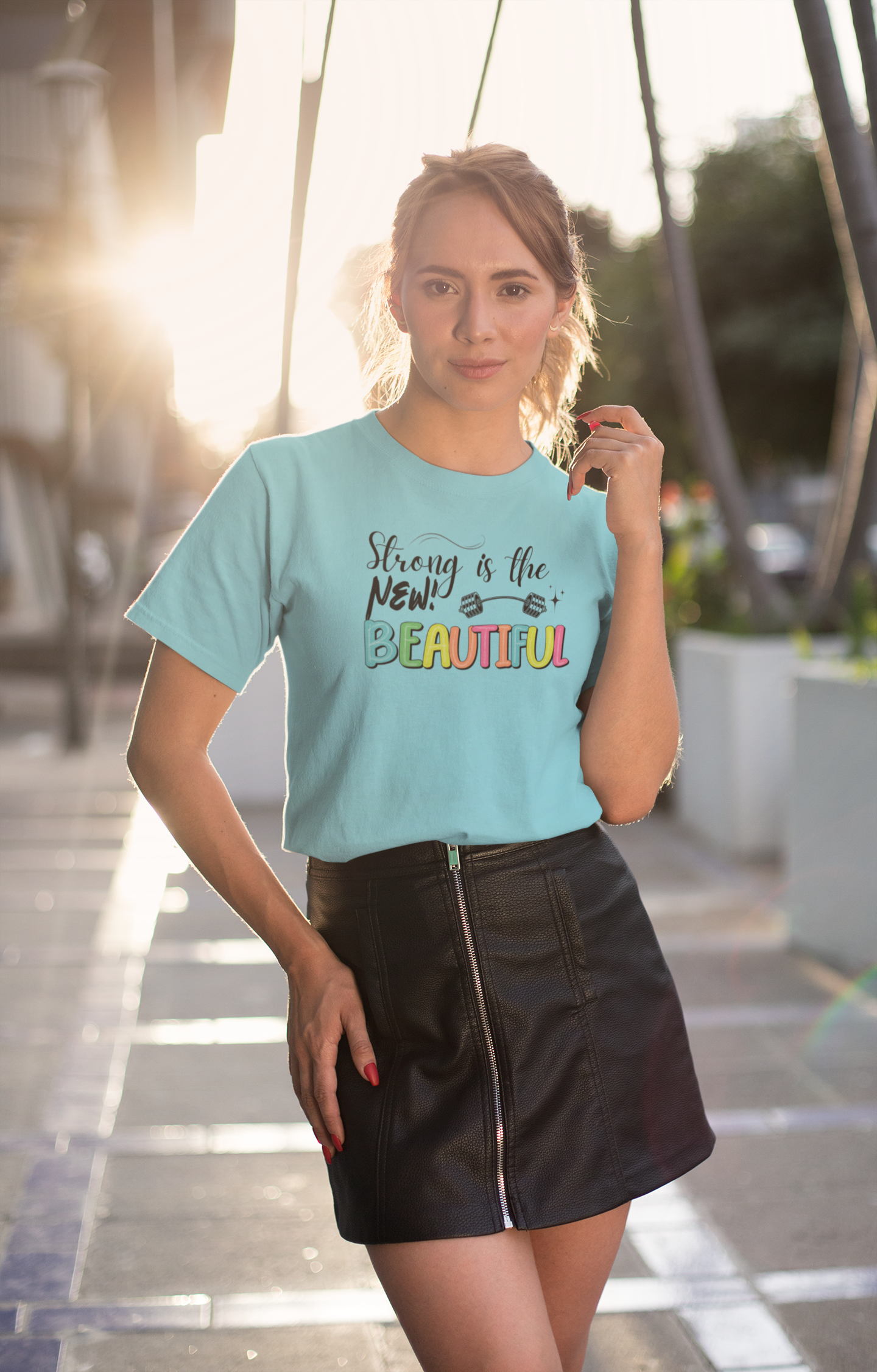 Woman wearing "Strong is the New Beautiful" t-shirt – casual fitness lifestyle look