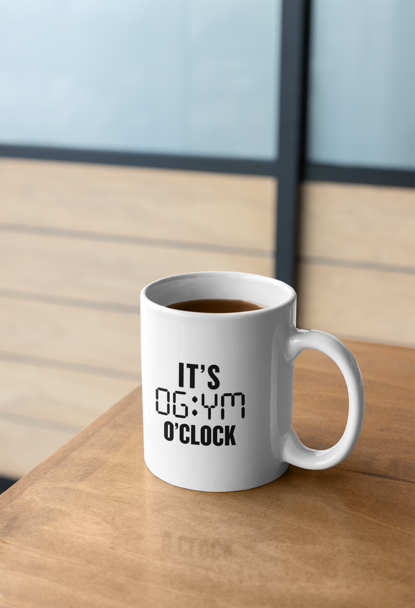 Funny gym quote mug – It’s Gym O’Clock ceramic cup by window